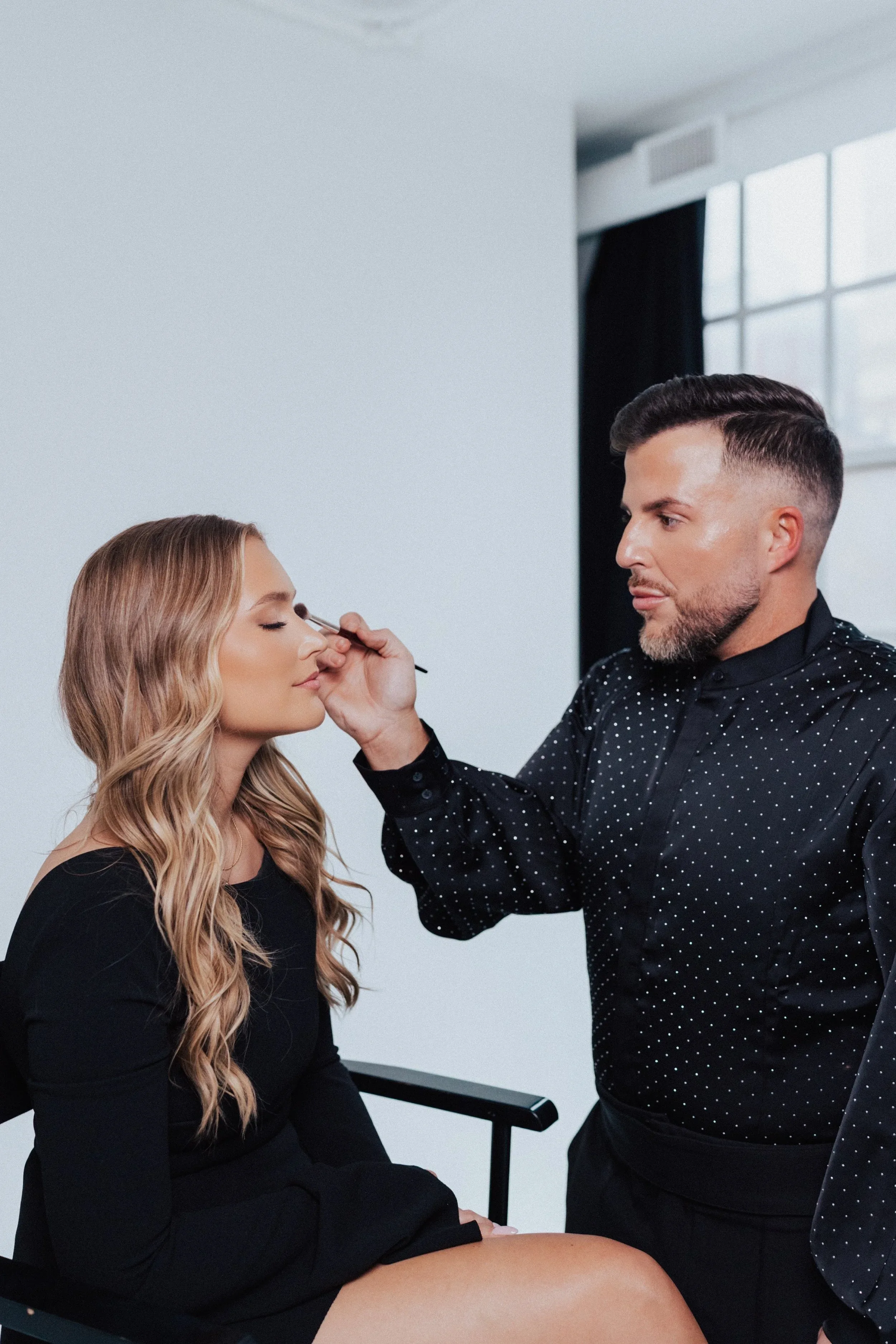 Makeup artist applying makeup to a salon client