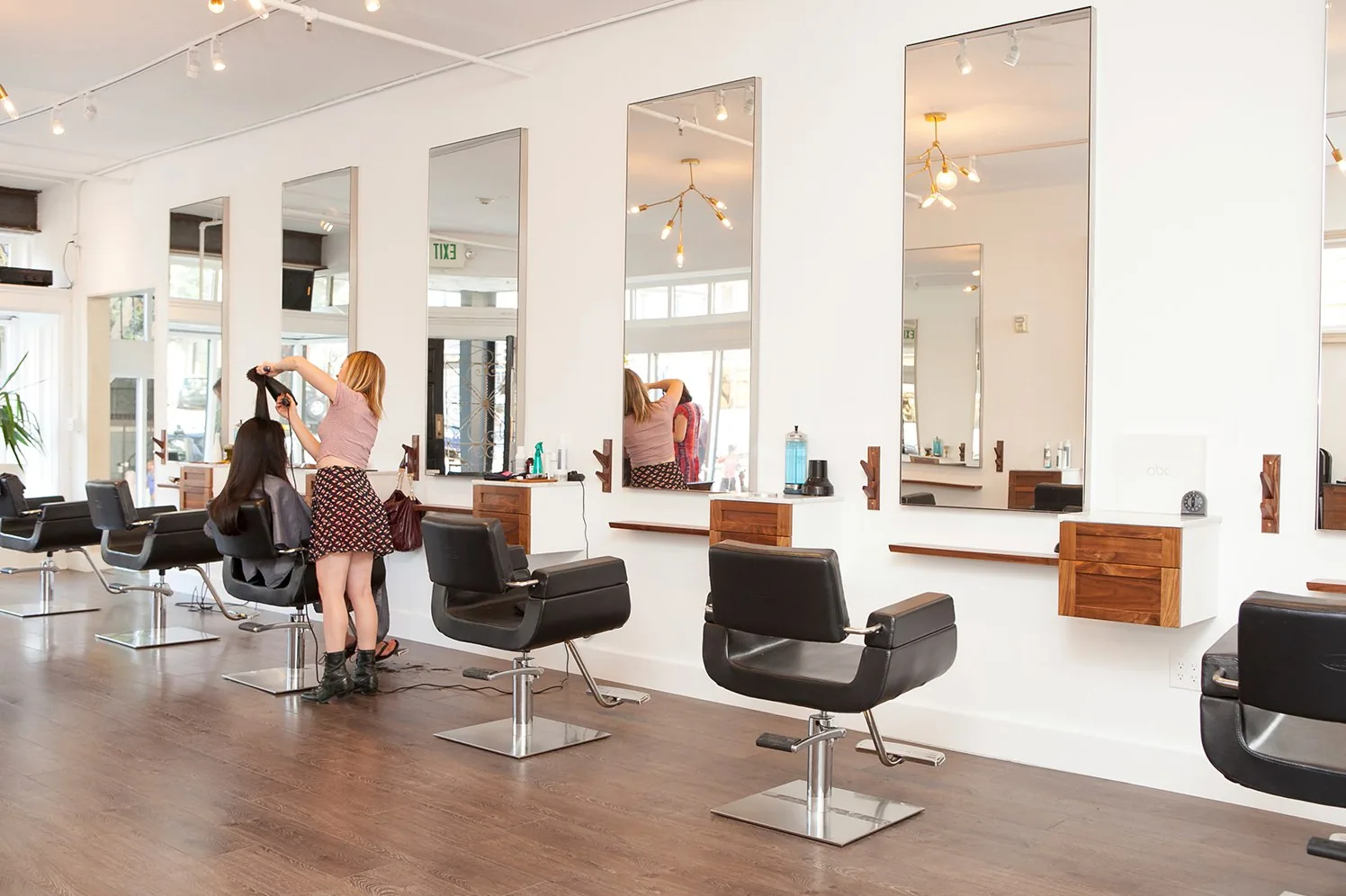 Bright professional salon interior with styling stations
